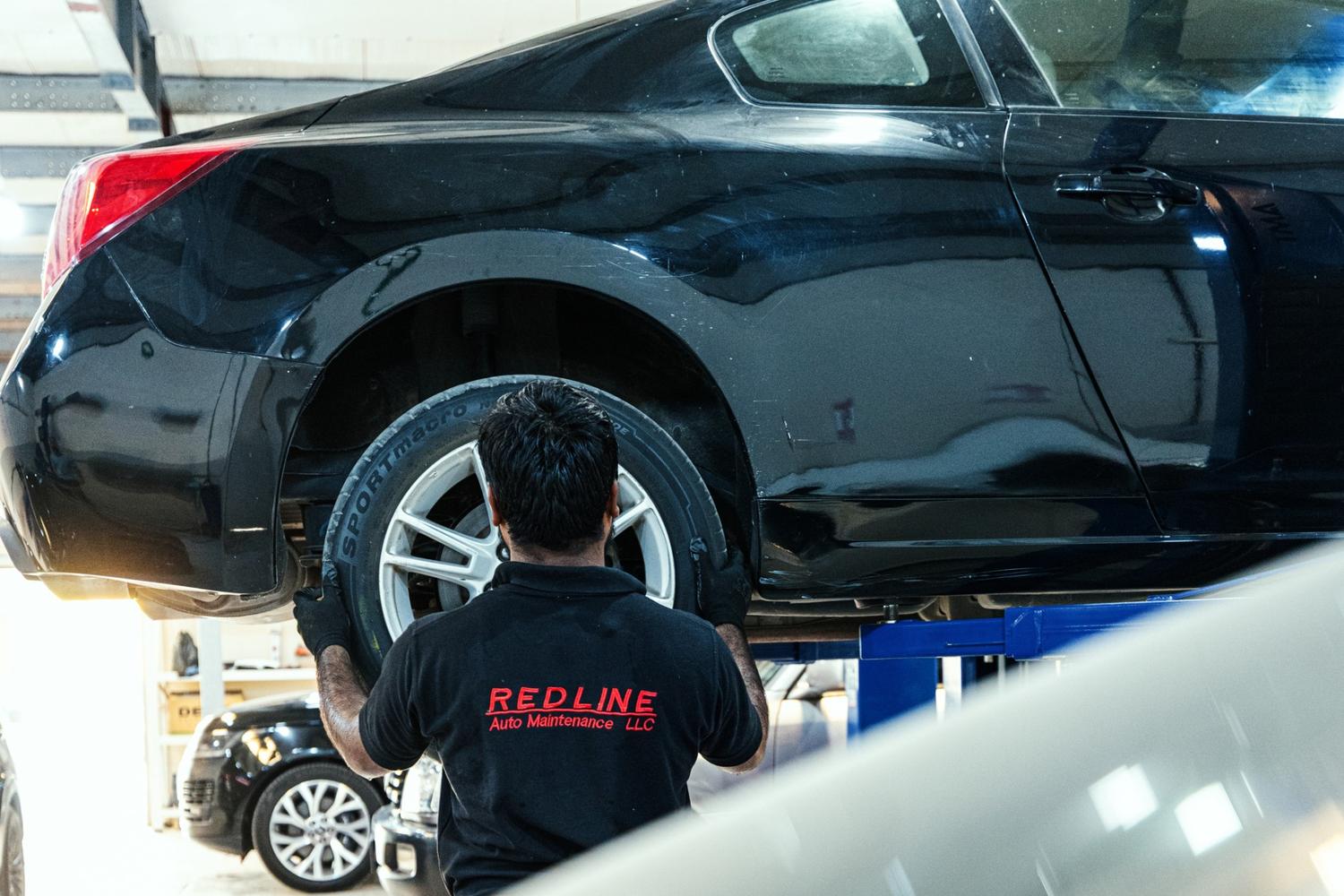 Technician carrying out a diagnostic check on a car engine